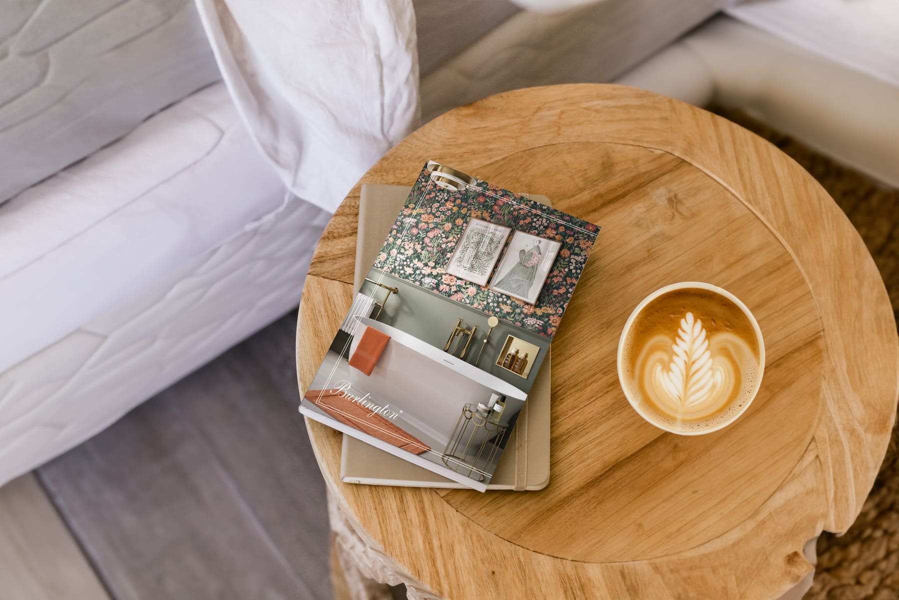 Burlington magazine, notebook and coffee on a wooden table