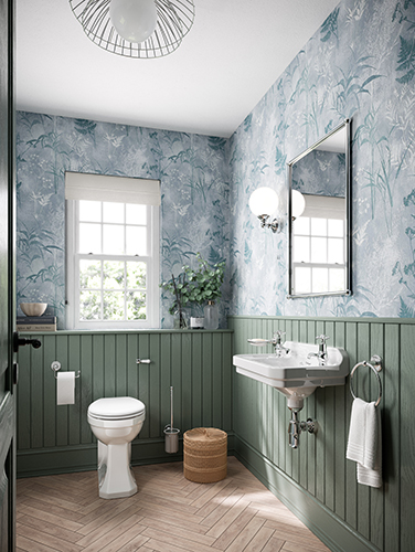 Deep green panels on the bottom half of these bathroom walls perfectly compliments the blue and white leafy wallpaper. The white ceramics allow the colours to pop. Luxury bathroom ceramics in a dopamine decor inspired bathroom