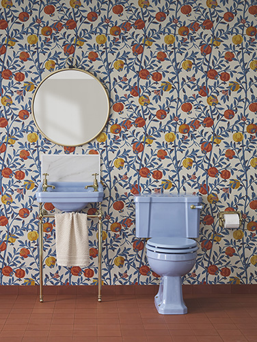 The Alaska Blue Bespoke basin and toilet are set against a green, red and yellow floral bathroom wallpaper. Bespoke by Burlington Alaska Blue bathroom ceramics