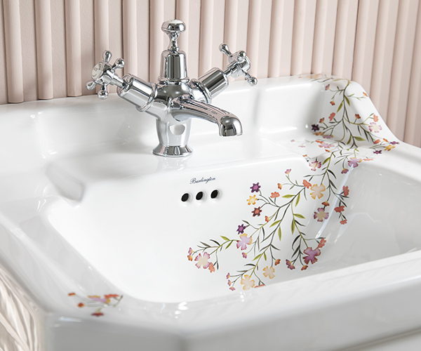 This close up of a white ceramic basin showcases the beauty of the floral design printed onto its surface. Bespoke by Burlington floral design basin