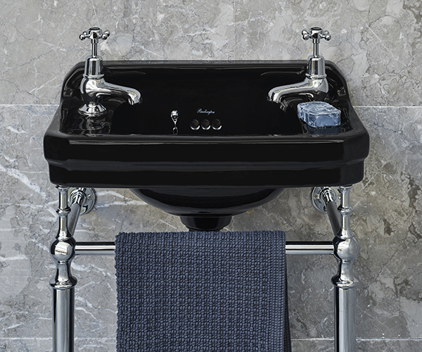 A close up a luxury basin finished in Jet Black with Chrome legs. Set against a neutral grey tiled wall, the black becomes the main focus, giving a air of elegance. Jet Black Burlington basin
