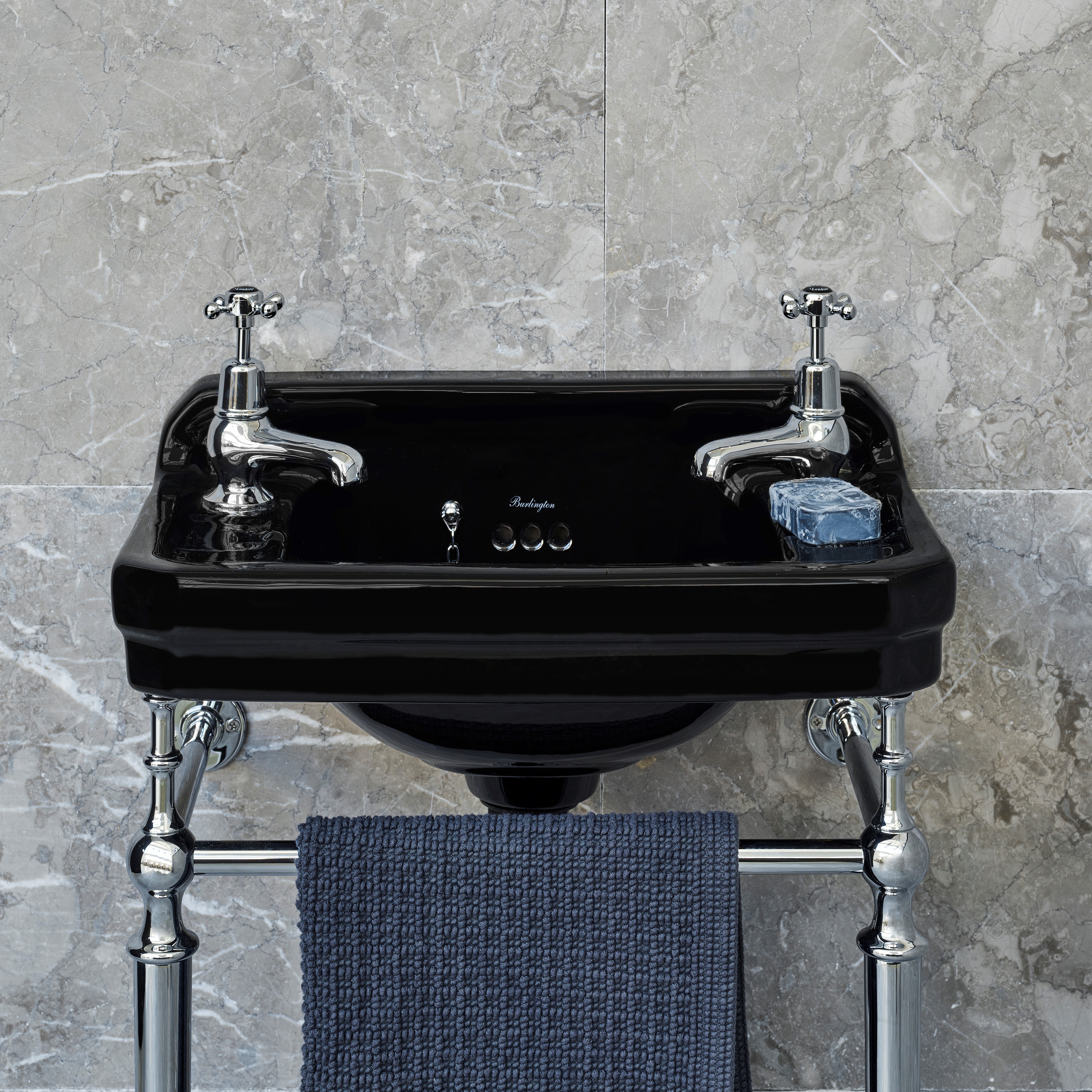 The sophistication of a traditional basin design and the use of a Jet Black finish against a grey marble tile ensures a luxurious atmosphere in this cloakroom. Edwardian Cloakroom Basin in Jet Black.